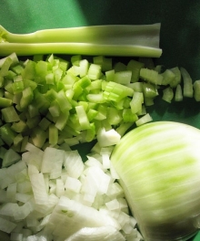 diced onion and celery with knife